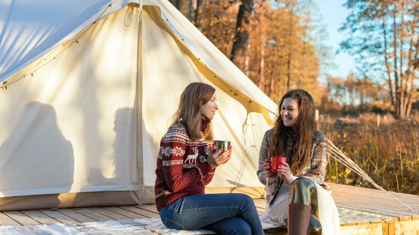 Image of 2 ladies chatting outside a bell tent
