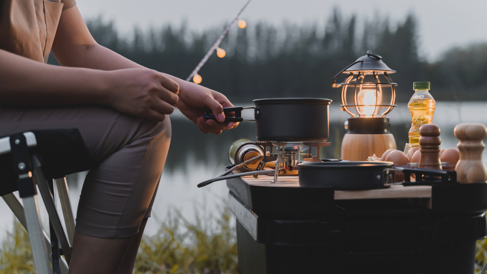 Image of a lady cooking on a camping stove